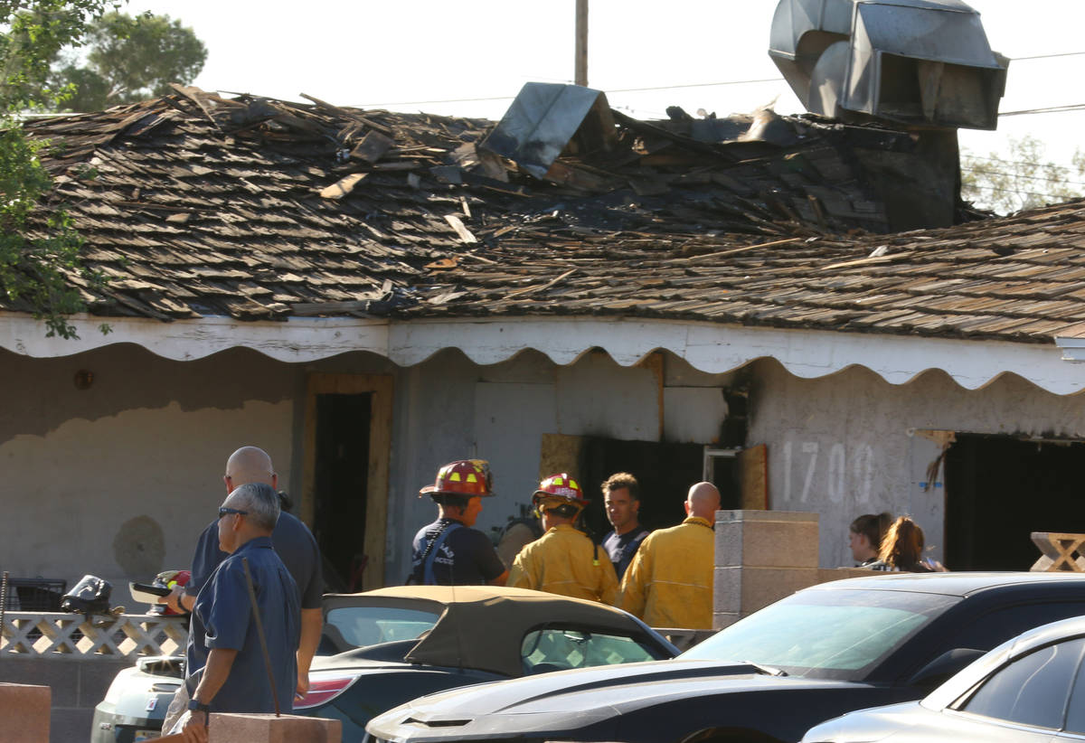 Las Vegas firefighters investigate the cause of a vacant house fire at 1700 Howard Dr. on Monda ...