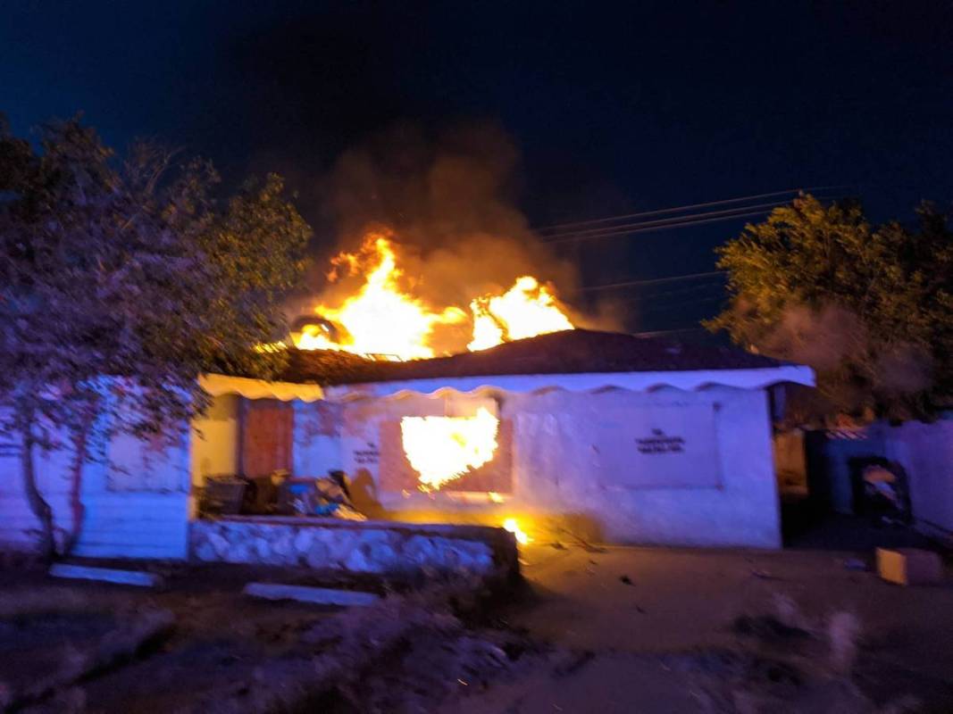 Flames come from a boarded-up house at 1700 Howard Dr. on Monday, May 4, 2020. One person was f ...