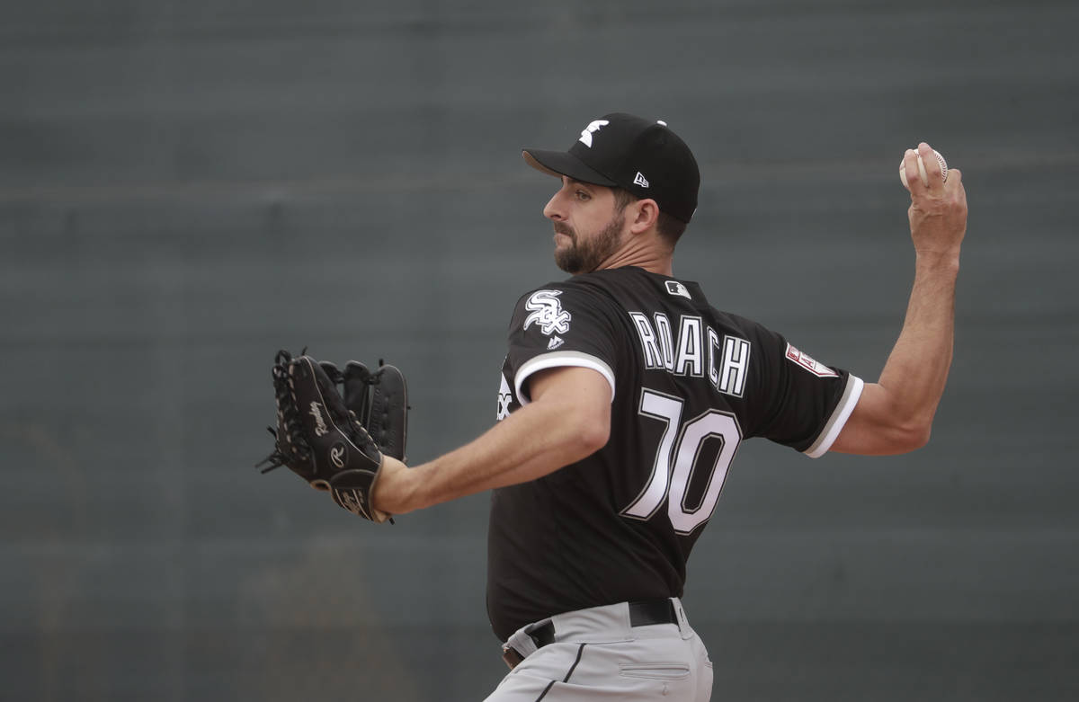 Chicago White Sox' Donn Roach throws during a spring training baseball workout Wednesday, Feb. ...