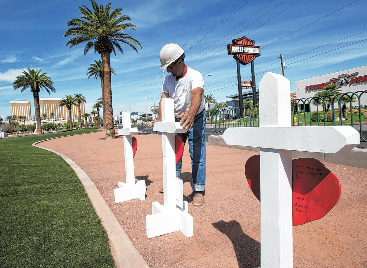 Greg Zanis, of Aurora, Ill., positions 58 crosses near the Welcome to Fabulous Las Vegas sign h ...