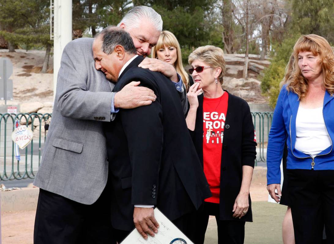 Clark County Commissioner Steve Sisolak, left, hugs Greg Zanis after declaring Sunday “Greg Z ...