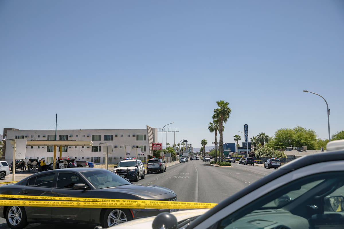 Las Vegas police investigate a downtown shooting in the 1900 block of Fremont Street in Las Veg ...