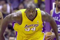 Los Angeles Lakers' Shaquille O'Neal, center, runs down the court after a monster slam dunk aga ...