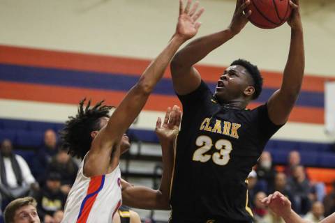 Clark's Antwon Jackson (23) goes to shoot the ball while under pressure from Bishop Gorman's Is ...