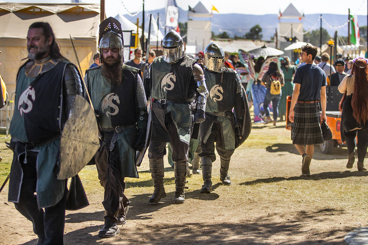 Knights make their way with others up the road about the Royal Court area during the Age of Chi ...