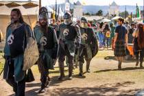 Knights make their way with others up the road about the Royal Court area during the Age of Chi ...
