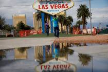 People wearing face masks visit the usually crowded "Welcome to Fabulous Las Vegas Nevada& ...