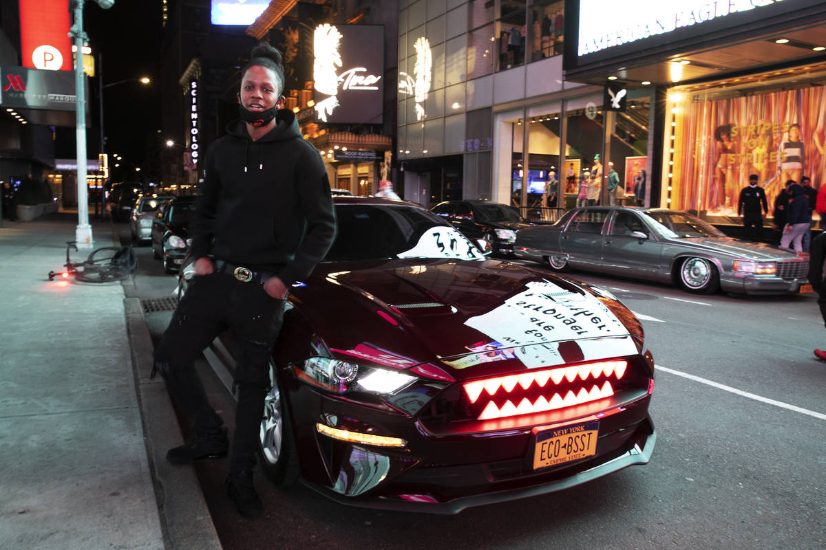 In this Saturday, May 2, 2020 photo, Andre Godfrey poses with his 2018 Ford Mustang EcoBoost - ...