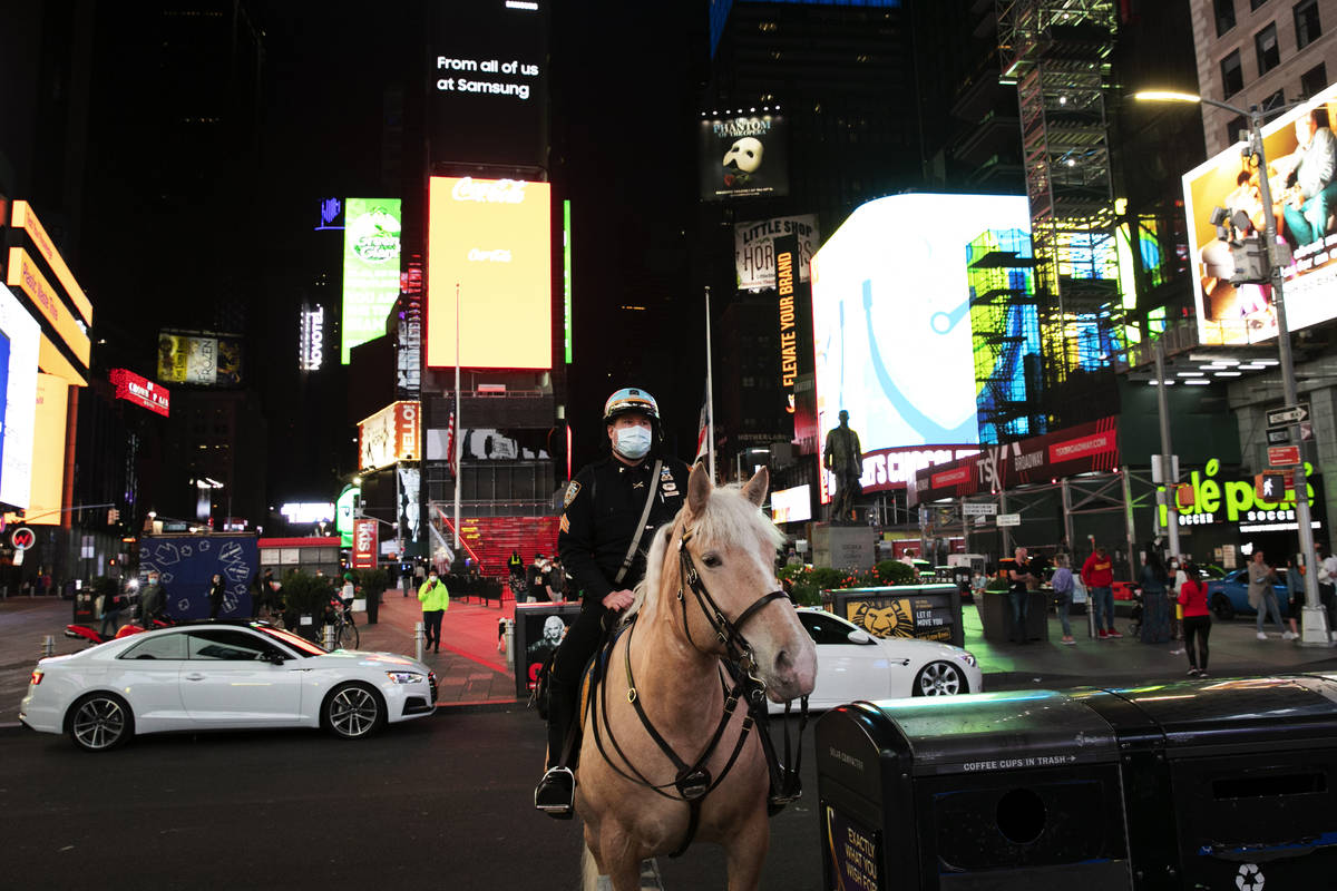 In this Saturday, May 2, 2020 photo, a New York City mounted police officer is posted in Times ...
