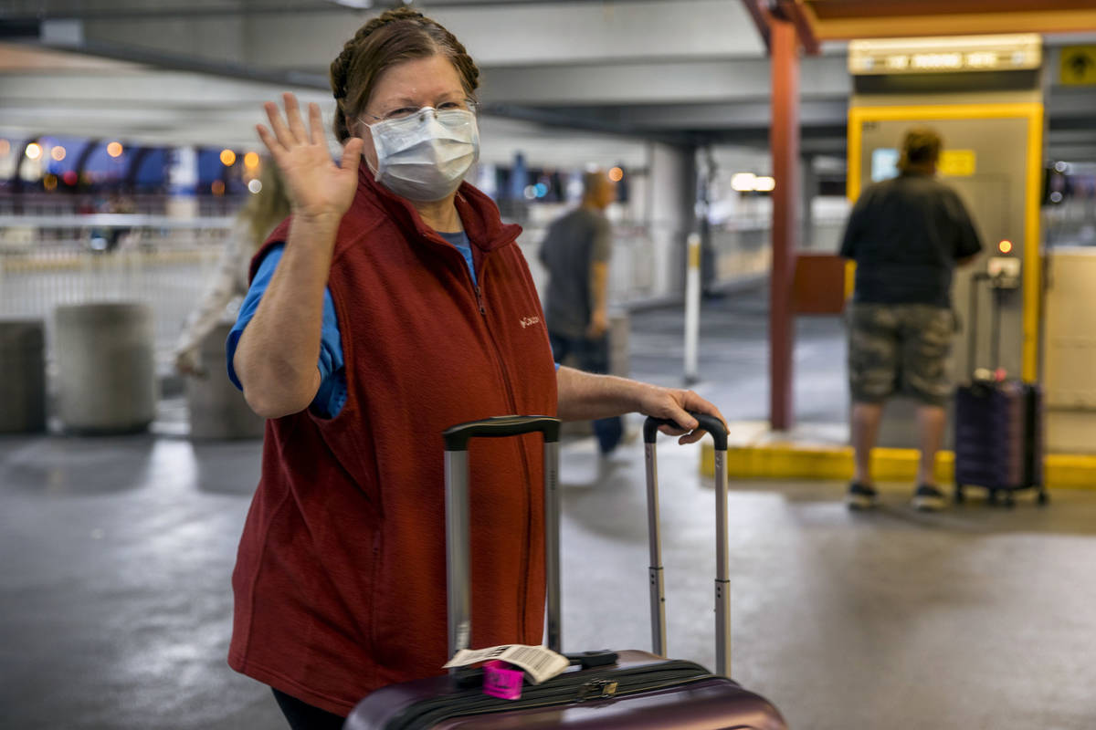 Susan Yowell waves goodbye as husband Jack pays for parking after arriving at McCarran Internat ...