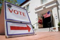 A woman walks out of a polling place after voting in the 2016 Nevada primary election in Las Ve ...