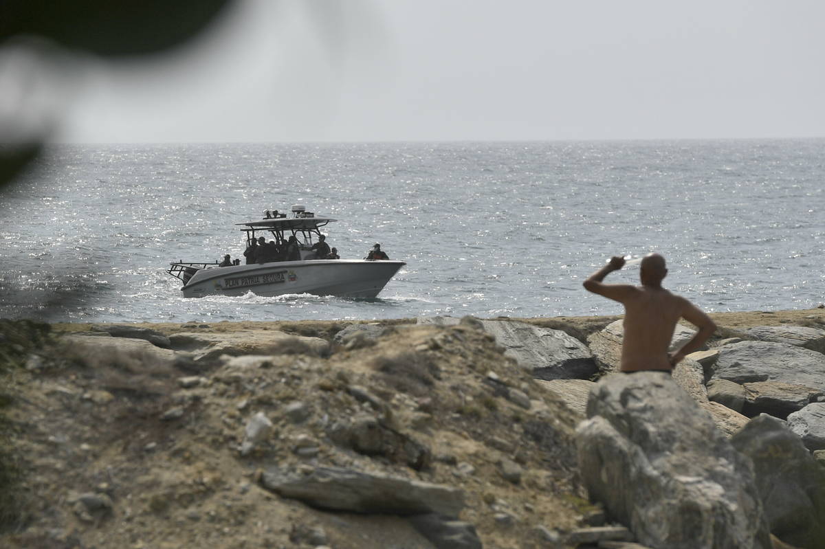 Security forces patrol near the shore in the port city of La Guaira, Venezuela, Sunday, May 3, ...