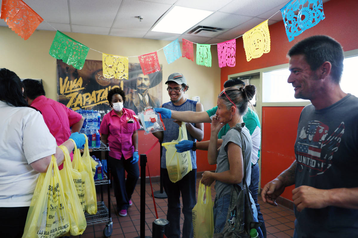 Individuals receive lunch and pandemic kits during a Cinco de Mayo celebration, provided by Viv ...