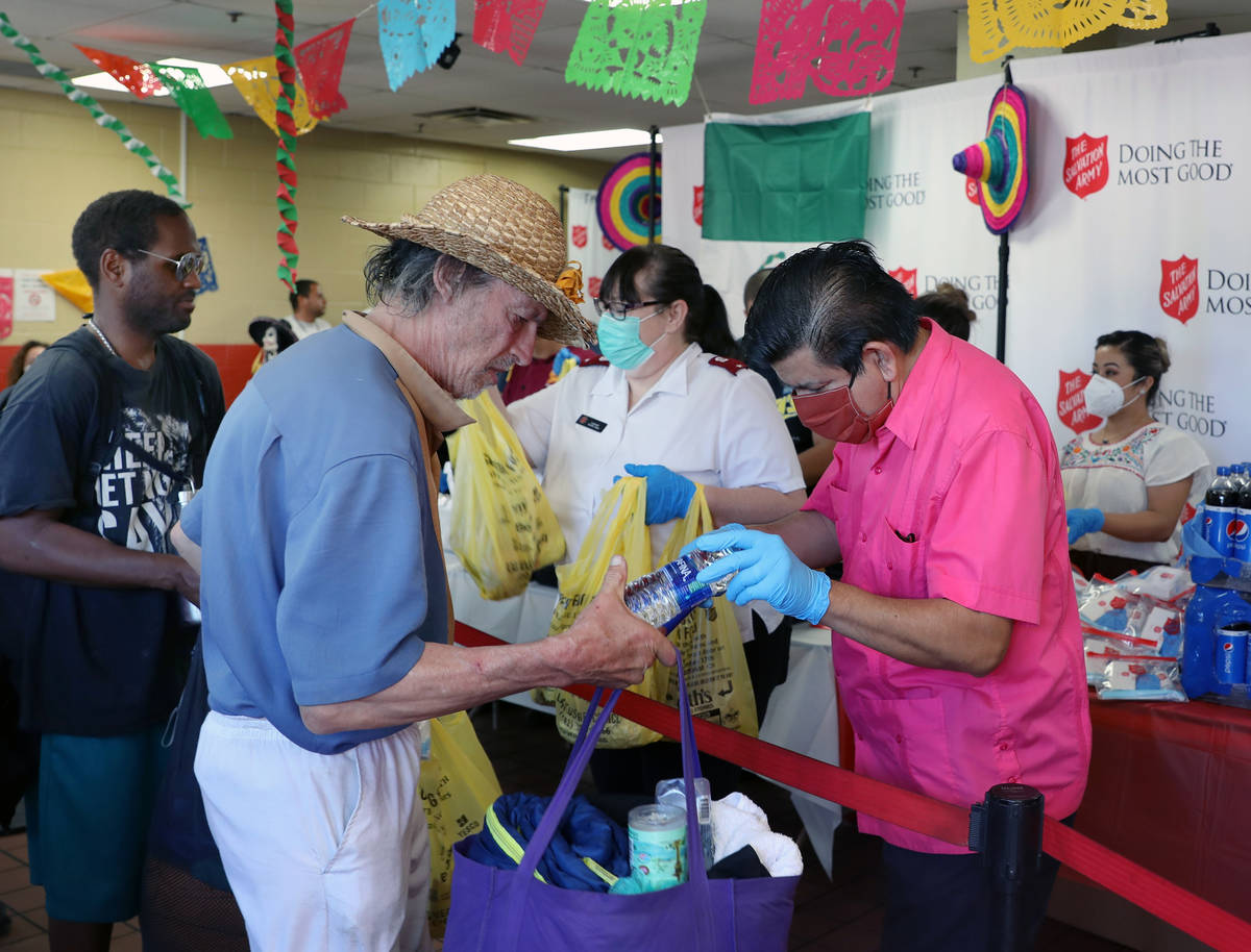 Individuals receive lunch and pandemic kits during a Cinco de Mayo celebration, provided by Viv ...
