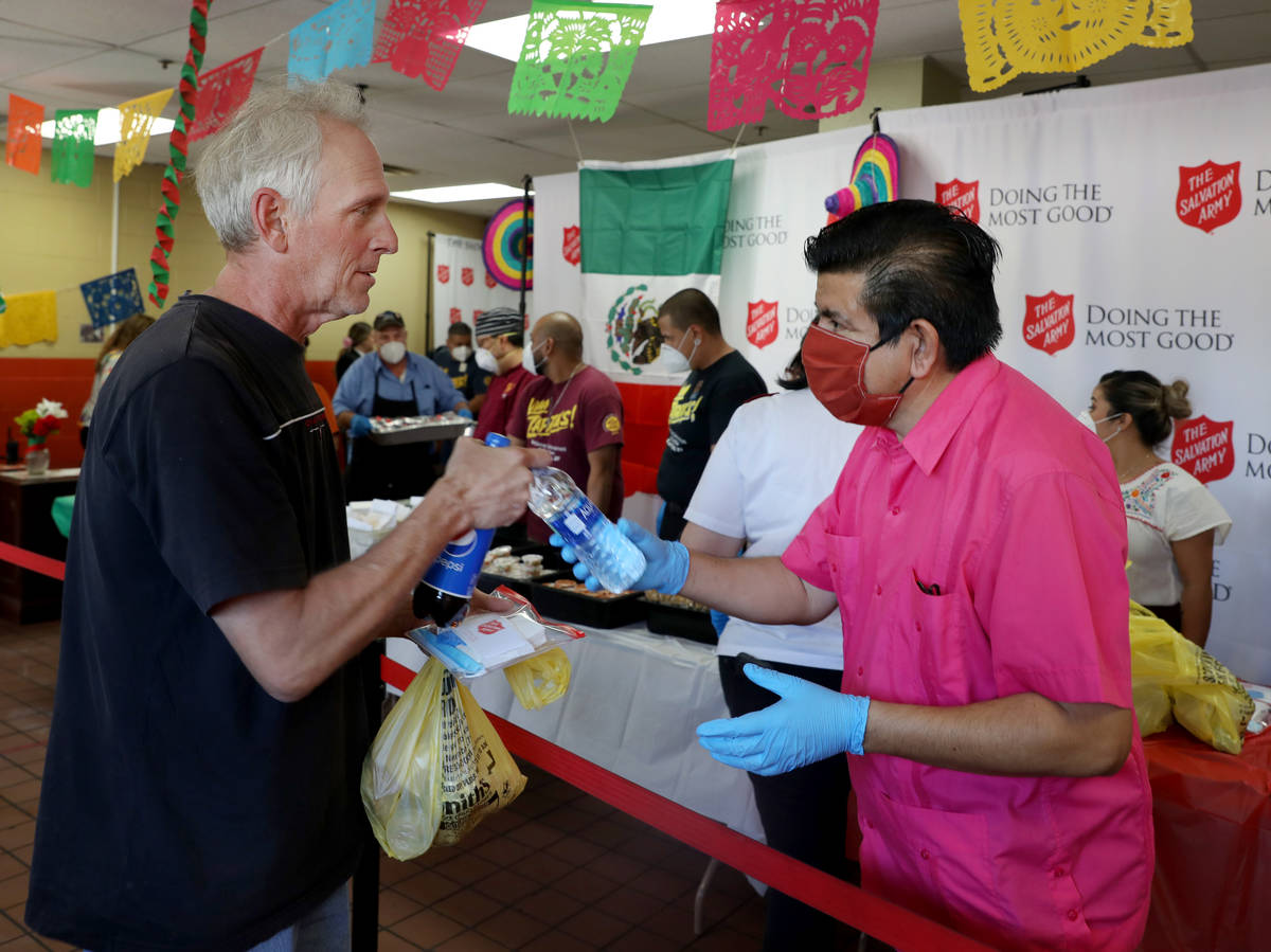 Vincent Vanderpool, left, receives lunch from North Las Vegas Councilman Isaac Barron during a ...
