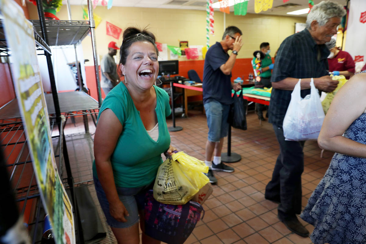 Resident at Salvation Army AnneMarie Lerate laughs as a live mariachi band plays during a commu ...