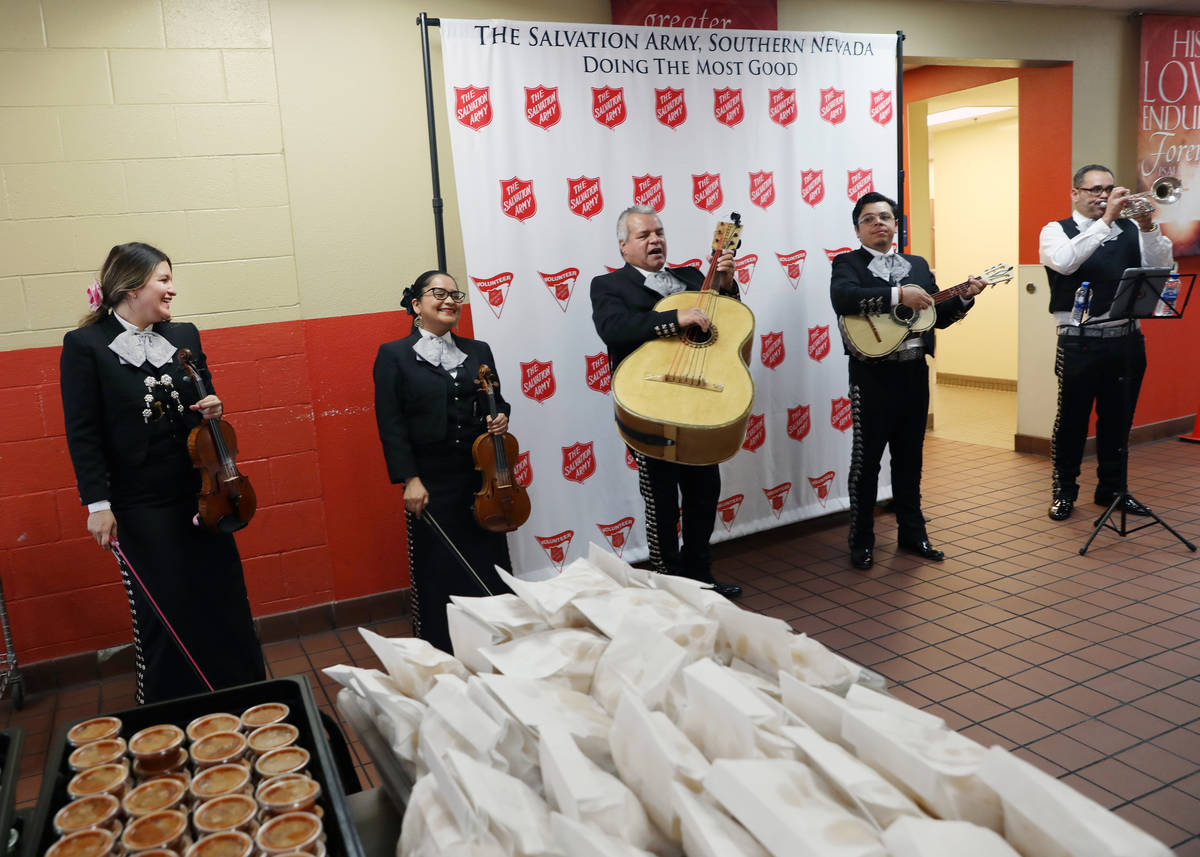 A mariachi band plays during a community lunch for a Cinco de Mayo celebration provided by Viva ...