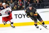 Golden Knights' Nate Schmidt (88) skates with the puck in front of Columbus Blue Jackets' Emil ...