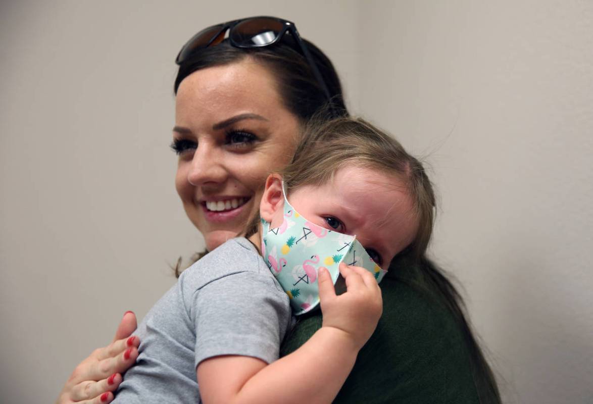 Olivia Hippert, 2, is comforted by her mother Amanda after she got her Hepatitis A vaccine at D ...