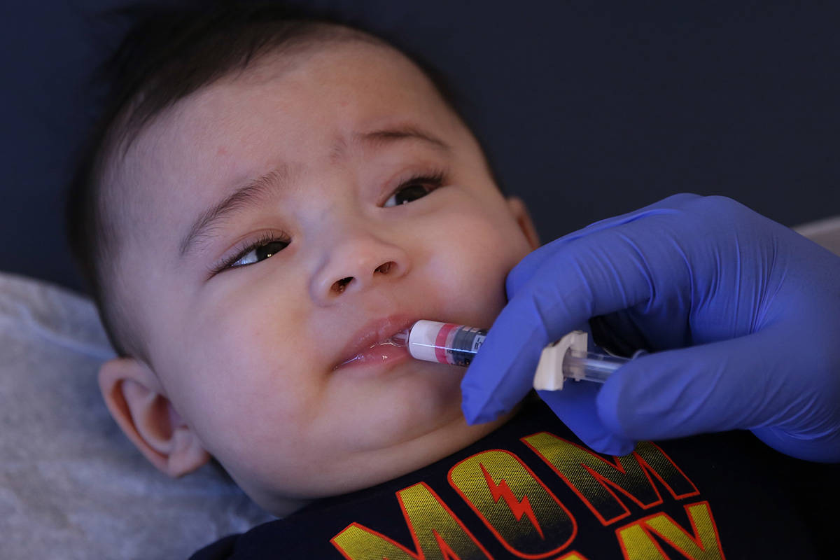 Aries Cano, 4, receives Rotavirus oral vaccine from Stephen Hibler, a medical assistant, at Des ...
