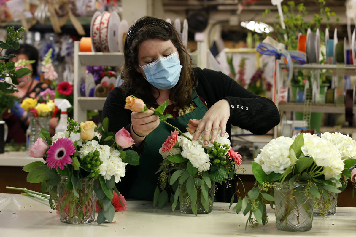 Tara Van Wieren works on a Mother's Day flower arraignment at Relles Florist in Sacramento, Cal ...