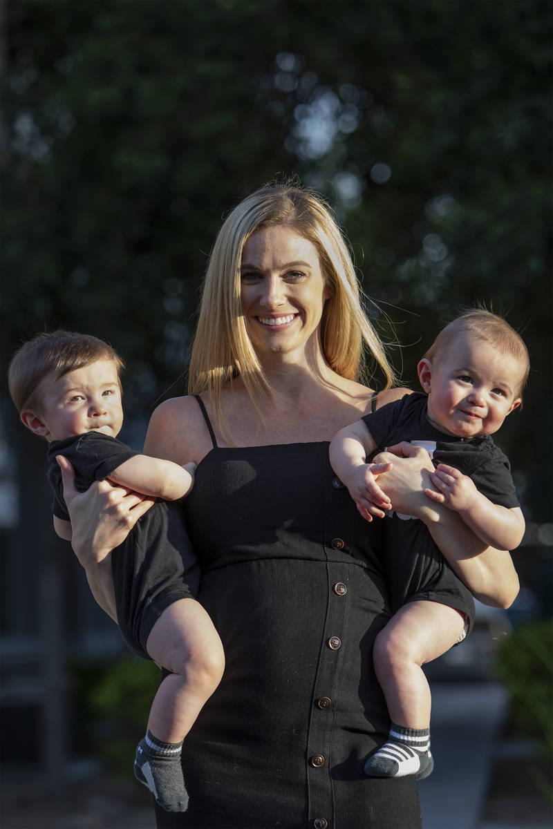 Shannon Belford pose for a portrait with her 9-month-old twin sons, Gavin and Garrett, outside ...