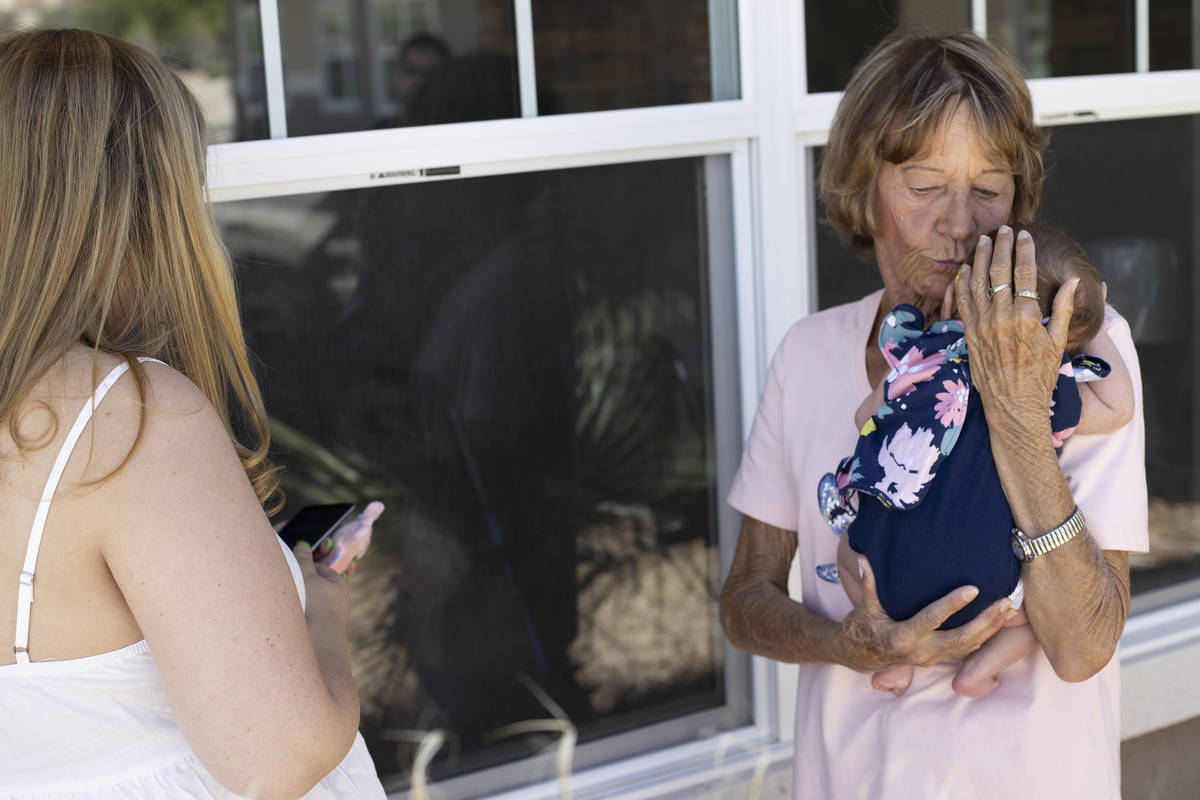 Alicia Jensen, 67, right, comforts her granddaughter Eliana, 1-month-old, as her daughter Chris ...
