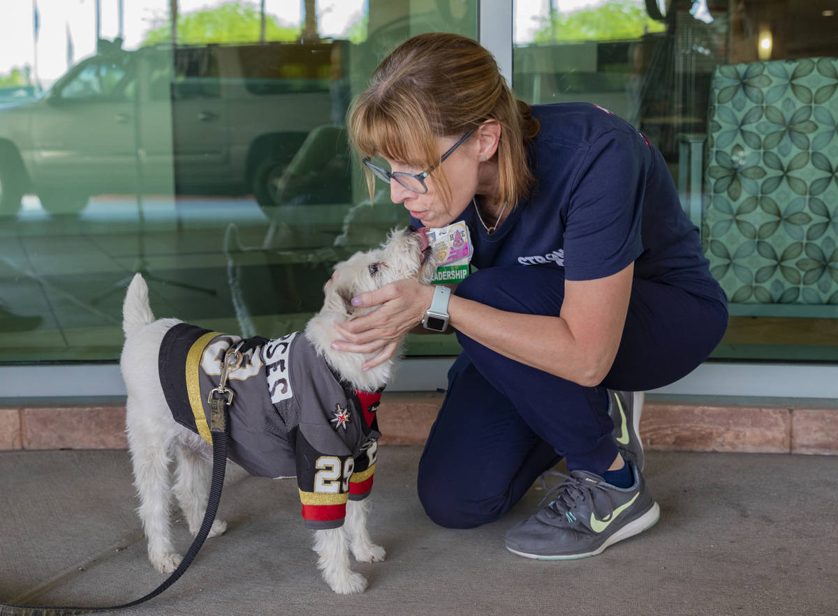 Clinical supervisor Stephanie Aceto receives a kiss from Bark-Andre Furry while he wears a Gold ...