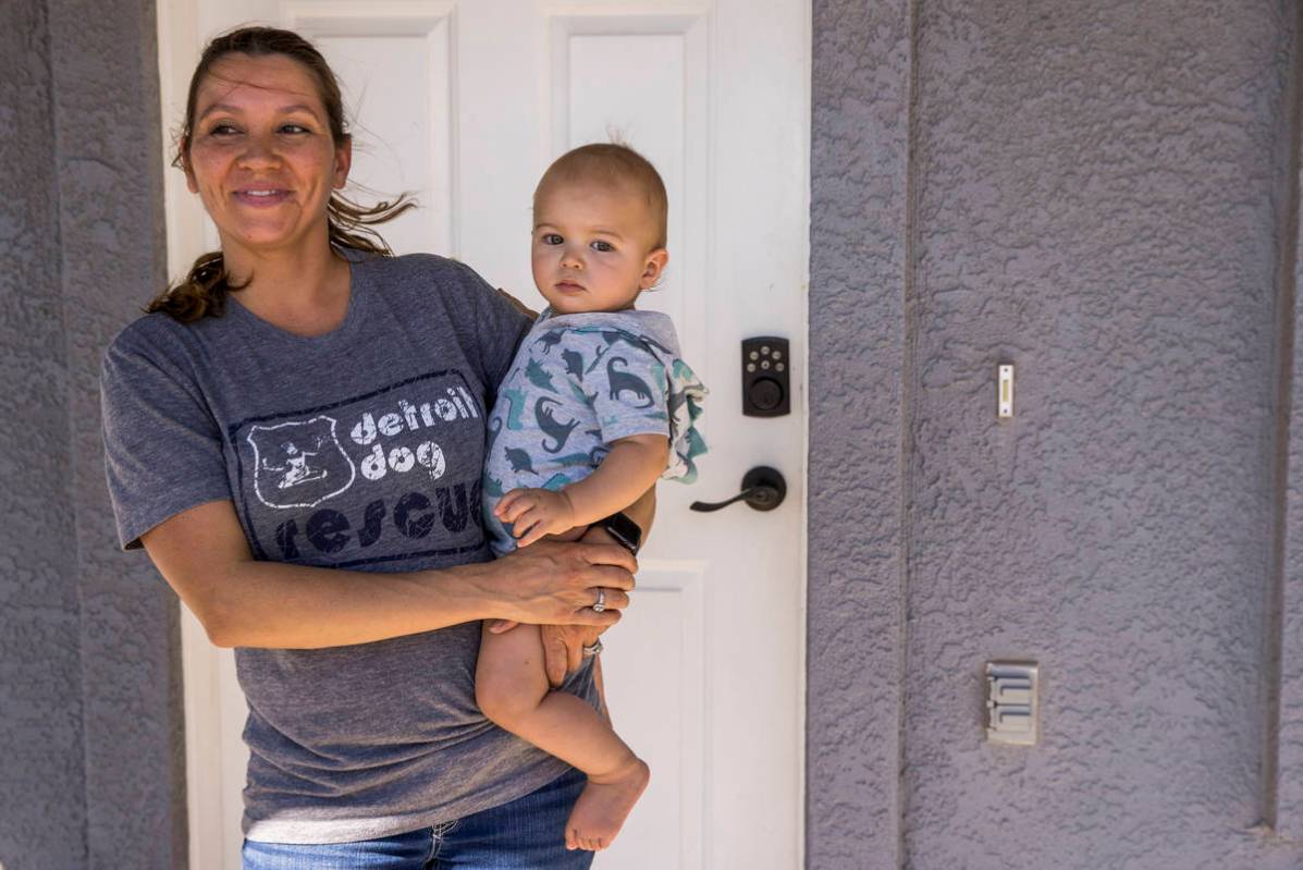 Jessica Zaharoff holds her son Jaxon, 1, while talking about life there during the coronavirus ...