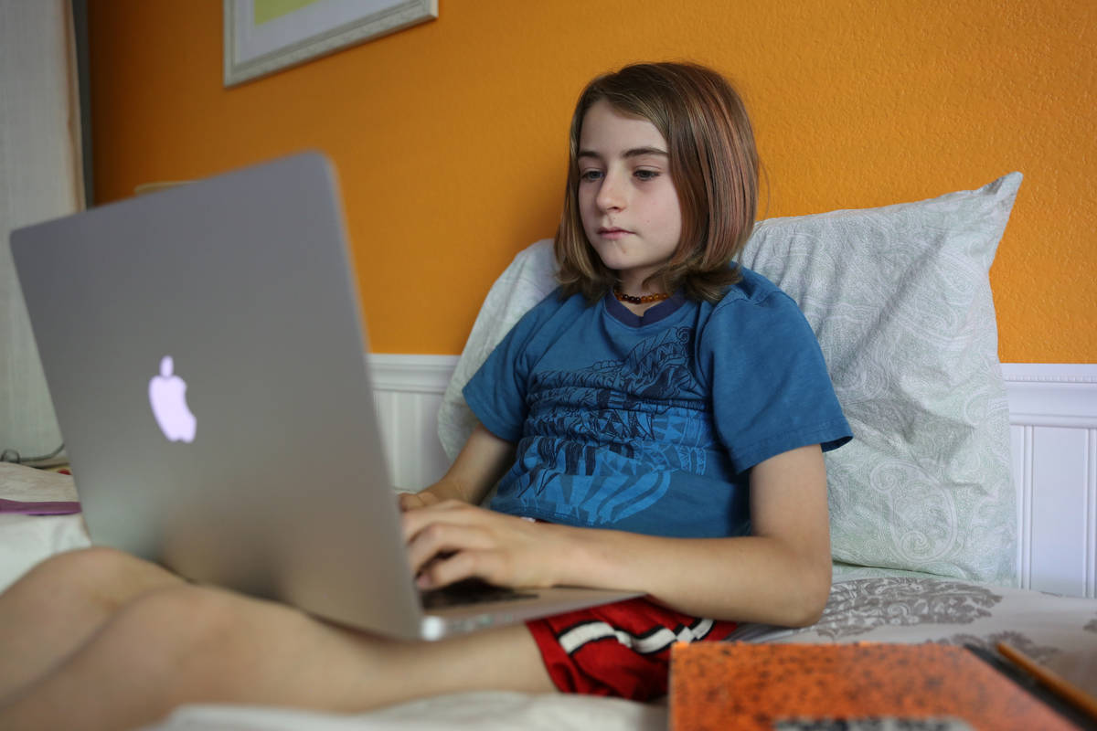 Levi Finfrock, a fifth-grade student at The Alexander Dawson School, does schoolwork at home. ( ...