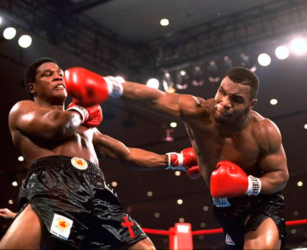 In this Nov. 22, 1986, file photo, Mike Tyson, right, delivers a blow to Trevor Berbick during ...
