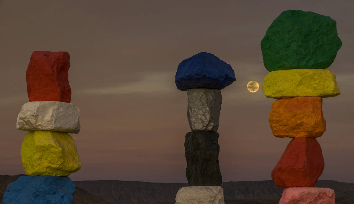 The moon rises over the Seven Magic Mountains outside Las Vegas on May 6, 2020.  The full moon ...
