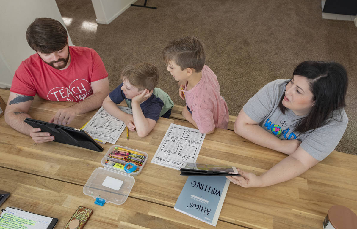 From left, Everett Mayville, 7, Christopher Houchins, a kindergarten teacher, Atticus Mayville, ...