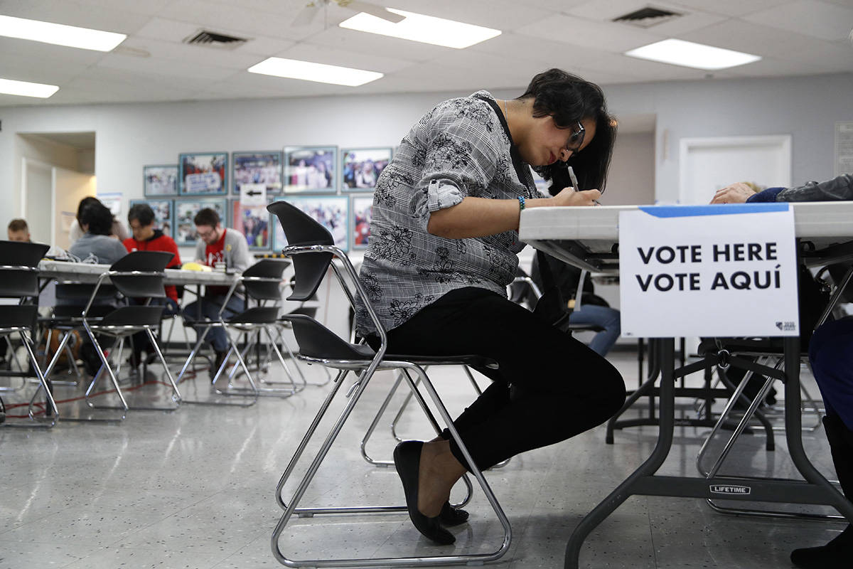 A woman votes at an early voting location at the culinary workers union hall, Saturday, Feb. 15 ...