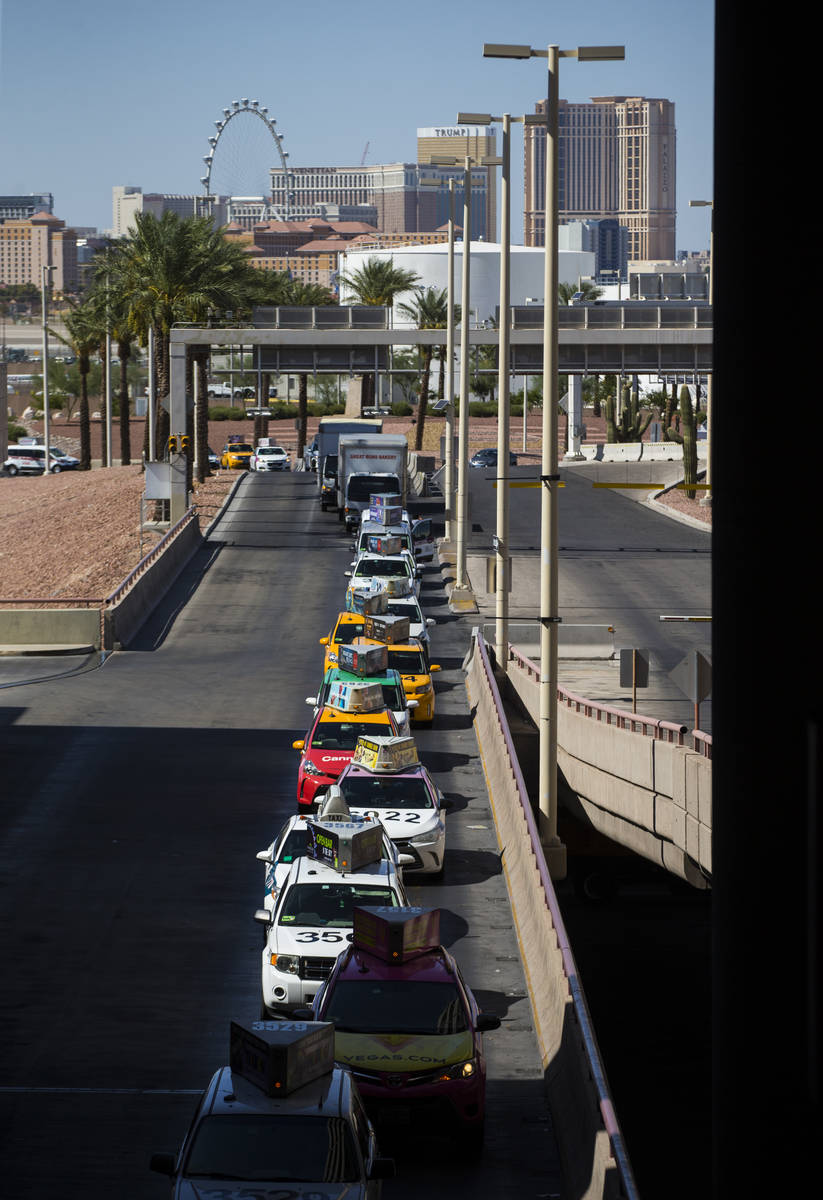 Taxis line up at McCarran International Airport ahead of the Labor Day holiday weekend in Las V ...