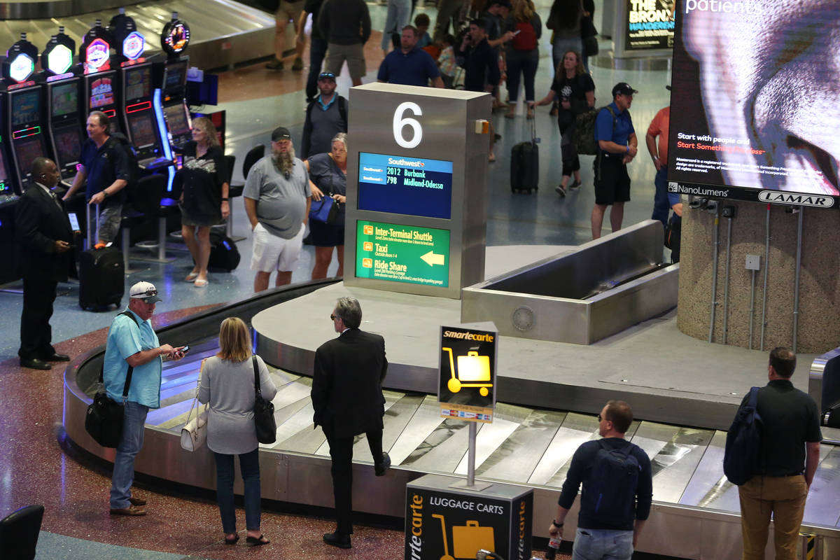 Passengers wait for their luggage in Terminal 1 at McCarran International Airport in Las Vegas, ...