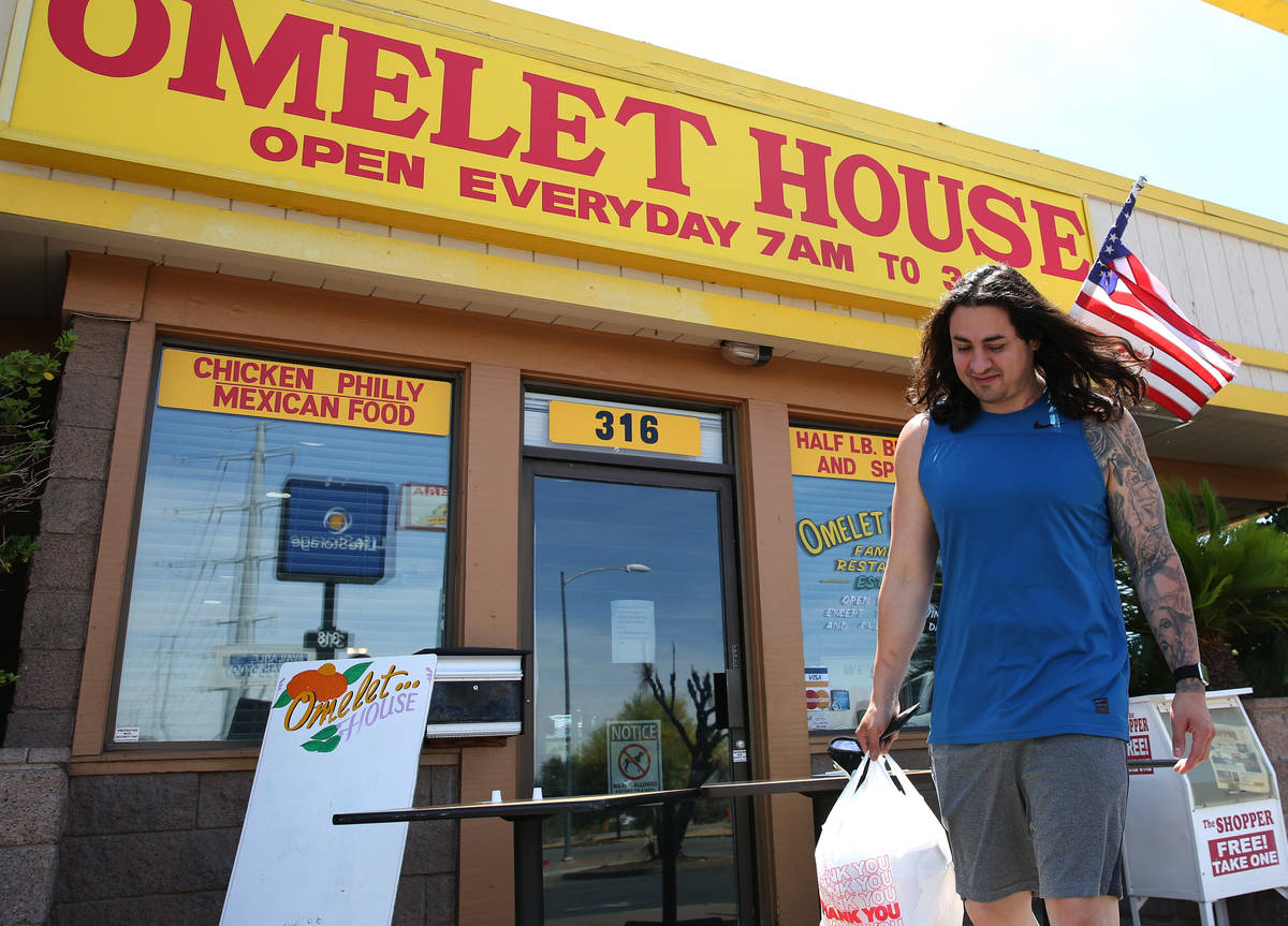 Aldo Salcedo picks up his order from a curbside pickup area at Omelet House on Wednesday, May 6 ...