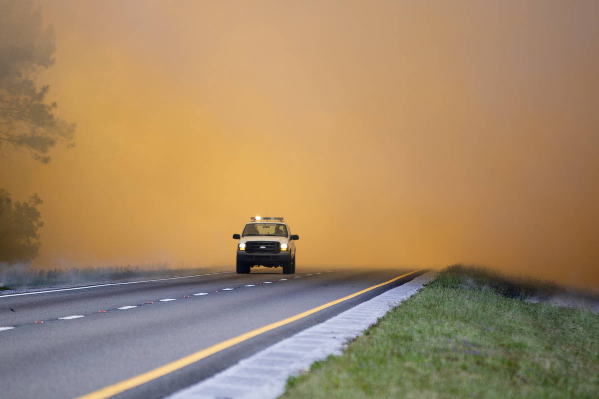 In this Wednesday, May 6, 2020 photo, a Forest Service vehicle makes its way along the I-10 hig ...