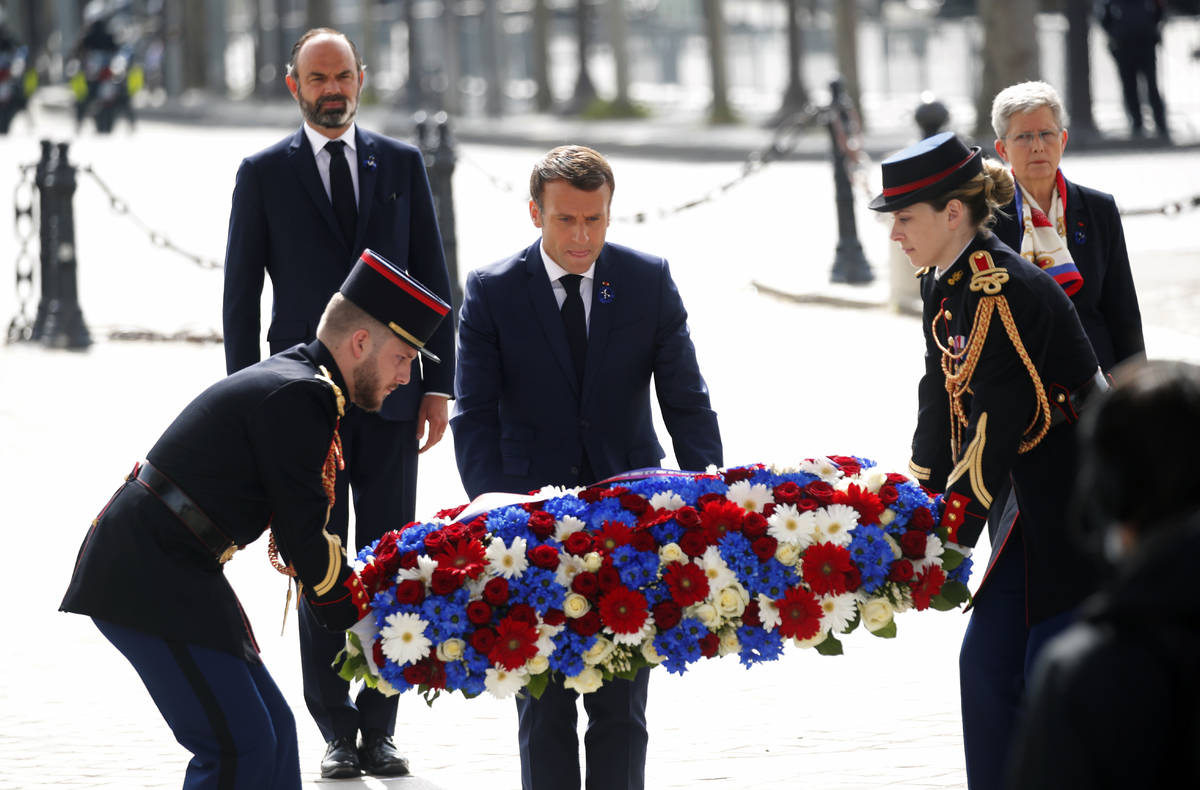 French President Emmanuel Macron lays a wreath of flowers during a ceremony to mark the 75th an ...