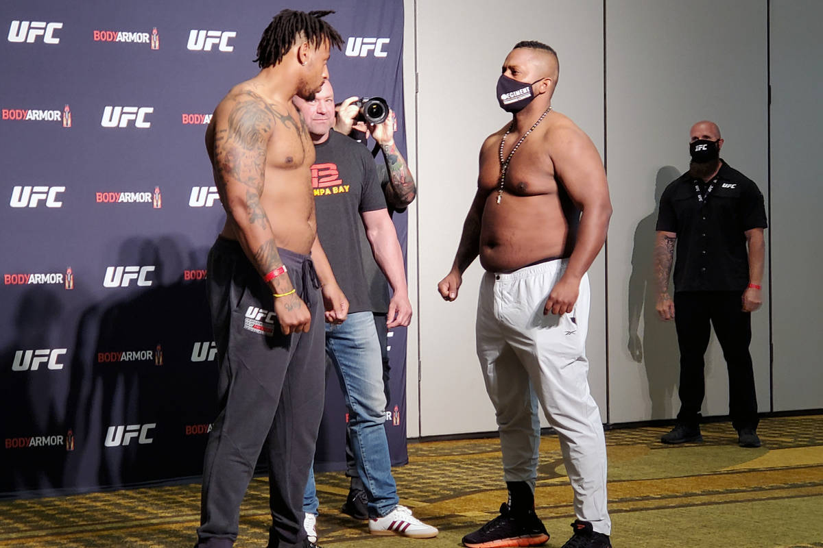 UFC heavyweight Greg Hardy, left, and Yorgan de Castro, right, engage in a staredown during the ...