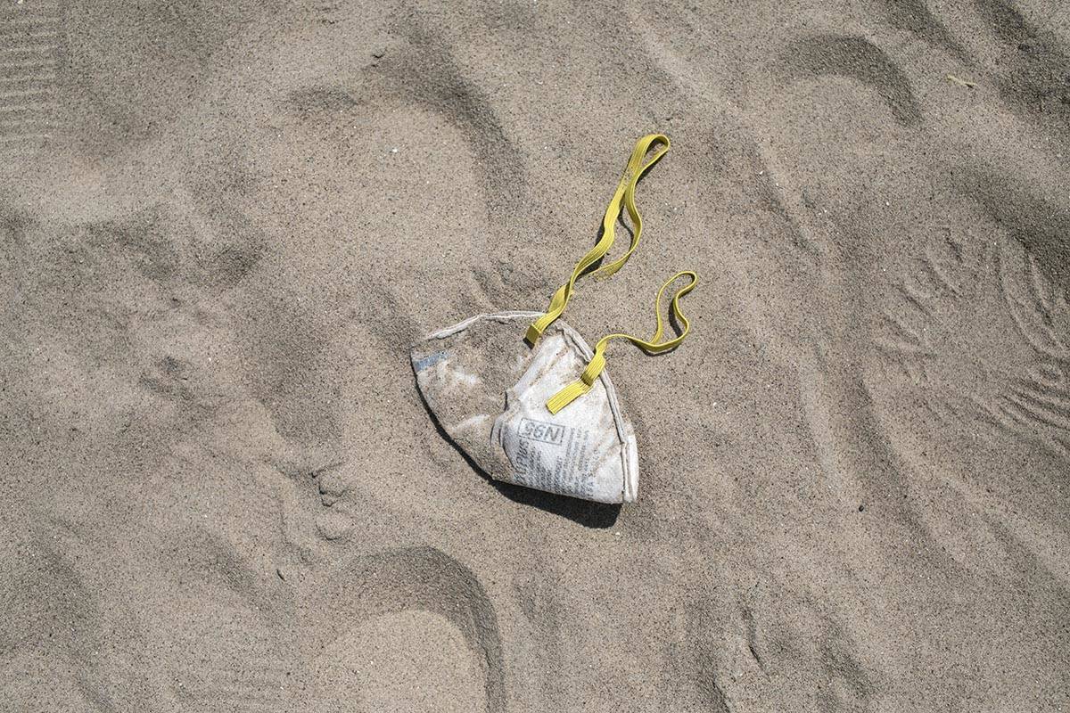An N95 protective face mask lies in the sand on Brighton Beach in the Brooklyn borough of New Y ...