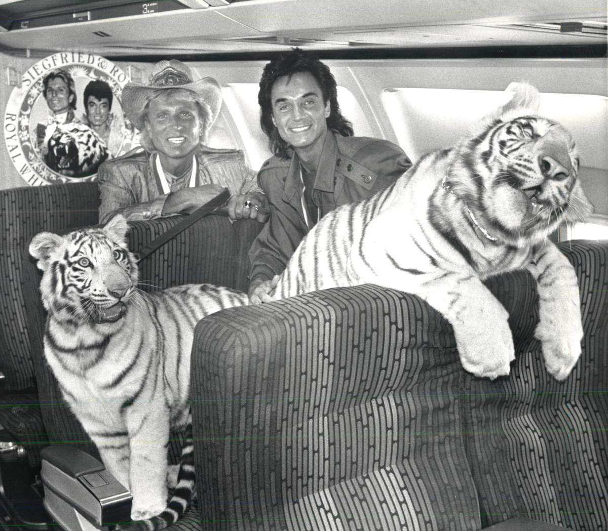 Siegfried and Roy pose for a photo with tiger cubs aboard and airplane in June 1987. (Review-Jo ...