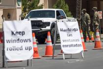 Members of the Nevada National Guard direct a person at the COVID-19 drive-through testing at ...