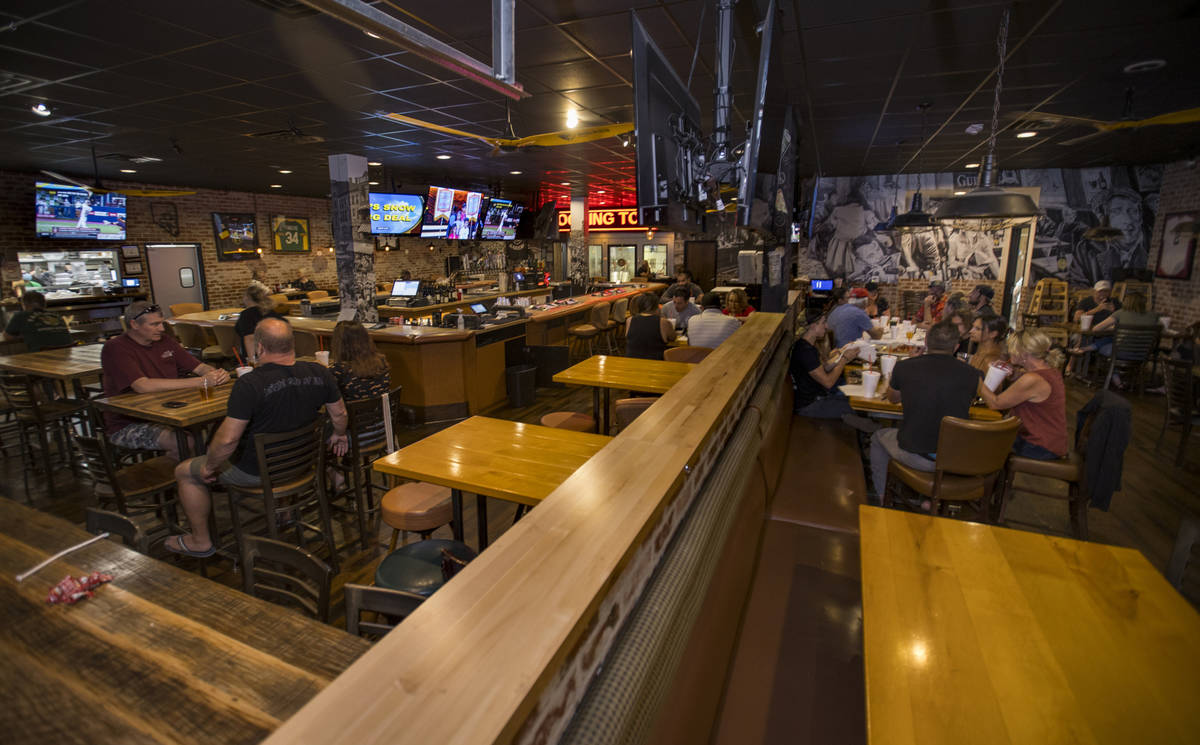The dining area is spaced with empty tables at Johnny Mac's Sports Bar & Grill now open aga ...