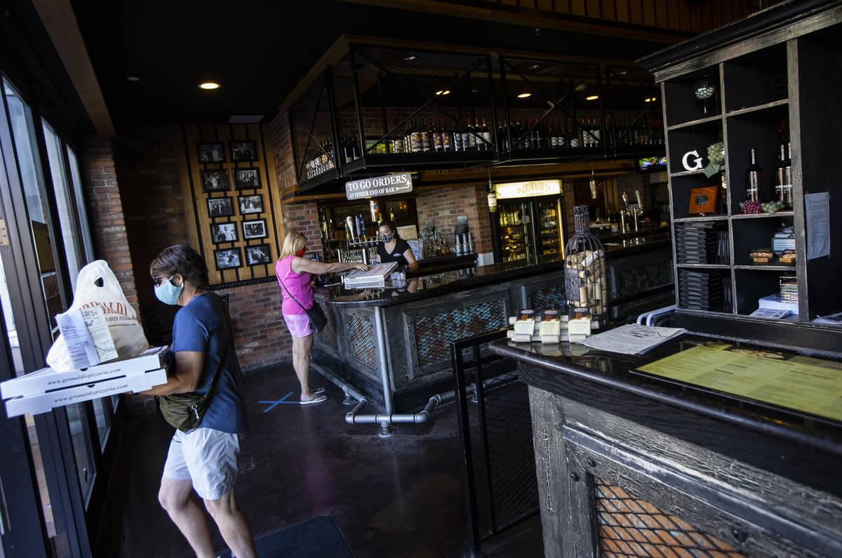 A customers stops by for a pickup order at Grimaldi's in Boca Park as some restaurants open for ...