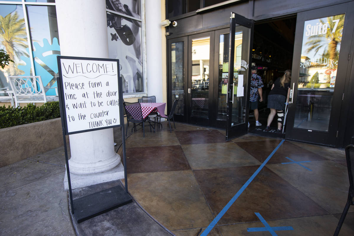 A sign directs customers at Grimaldi's in Boca Park as some restaurants open for table-service ...