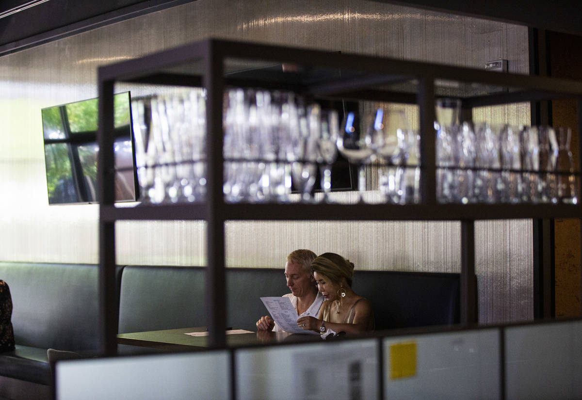 People dine at Wolfgang Puck Players Locker as some restaurants open up for table-service at Do ...