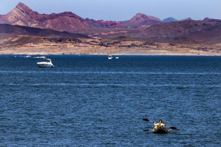 Kayakers paddle to deeper water in the Lake Mead National Recreation Area which is now open to ...