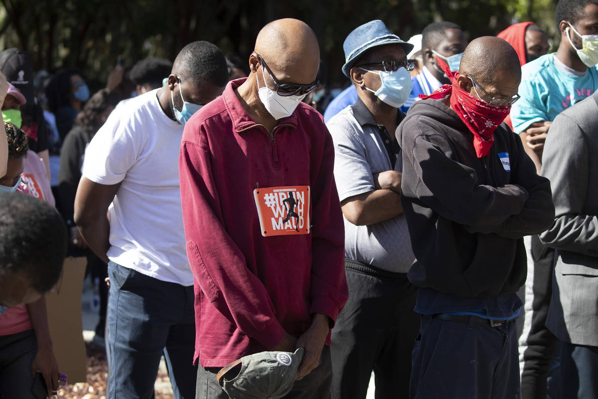 People pray during a rally to protest the shooting of Ahmaud Arbery, an unarmed black man Frid ...