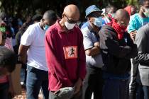 People pray during a rally to protest the shooting of Ahmaud Arbery, an unarmed black man Frid ...